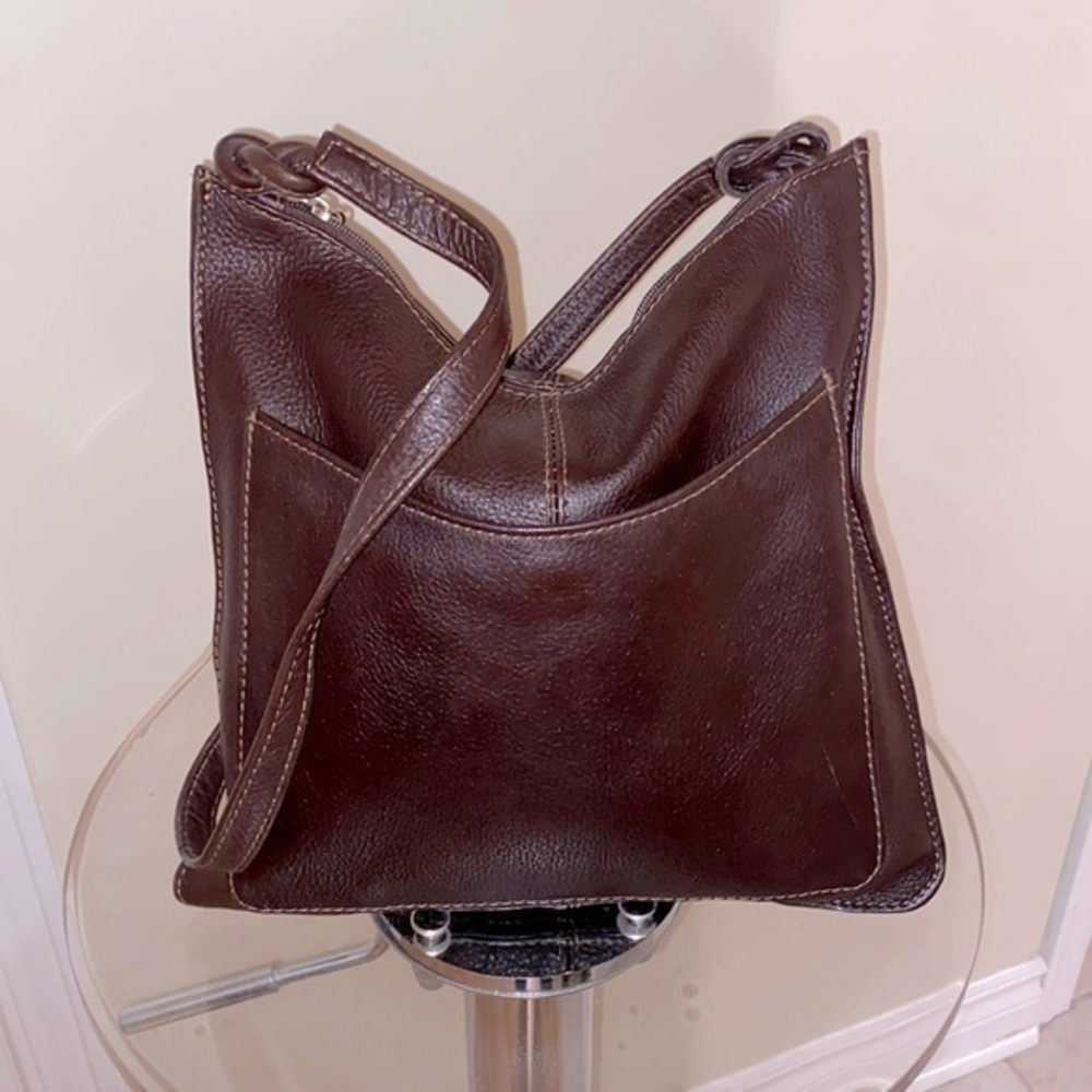 Genuine leather  unbranded bag w/silver tone zipper pull, knotted straps. 🤎